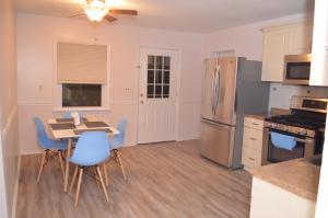a kitchen with a table and chairs and a refrigerator at La Casita Bonita Near NYC in Yonkers
