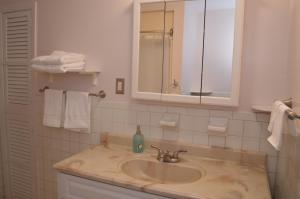 a bathroom with a sink and a mirror and towels at La Casita Bonita Near NYC in Yonkers +12 photos