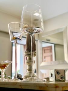 two wine glasses sitting on top of a table at Cassisi Hotel in Milazzo