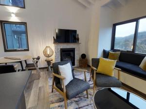 a living room with a couch and a fireplace at Studio Loft 18 - The Stables Perisher in Perisher Valley