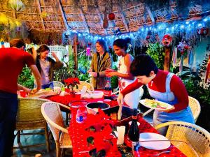 a group of people standing around a table with food at Hostal Casa Huasteca in Ciudad Valles