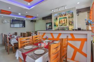 a restaurant with tables and chairs and a bar at Hotel Marinha in Pashupatināth +31 photos
