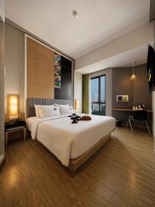 a bedroom with a large bed and a large window at MaxOne Platinum Hayam Wuruk in Jakarta