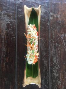 a plate of food on top of a banana leaf at CrazyGecko in Don Det