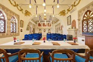 uma sala de conferências com uma grande mesa e cadeiras azuis em Bundelkhand Riverside em Orchha