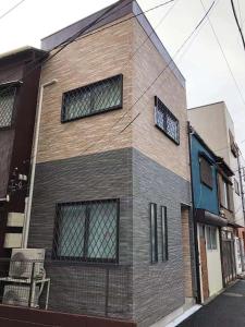 a building with three windows on the side of it at Re Tokyo II in Tokyo
