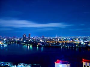 a view of a city skyline at night at Hotel Keihan Universal Tower in Osaka