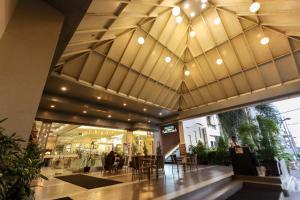 a lobby of a shopping mall with a large ceiling at Paseo Premiere Hotel in Santa Rosa