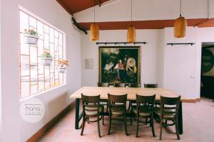 a table and chairs in a room with a painting on the wall at Thien Phu Garden Hotel in Hanoi