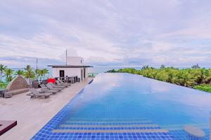 a large swimming pool on a patio with a house at Boracay Ocean Club Beach Resort in Boracay