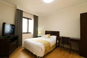 Beijing Lido Place Apartment tesisinde bir odada yatak veya yataklar