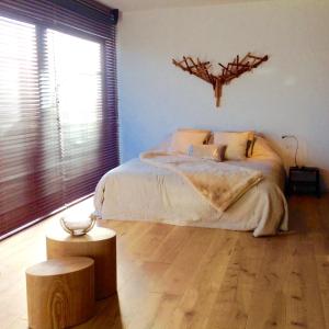 a bedroom with a bed and a large window at 22ndFloor Luxury Suite in Ostend