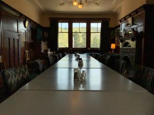 a large long table in a room with chairs at Beaumont Hotel and Holiday Park in Lawrence