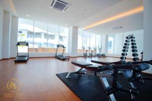 a gym with cardio equipment in a large room with windows at The Wave Residence Melaka in Melaka