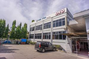 a car parked in front of a building at OYO 2180 Vina Vira Hotel in Lhokseumawe