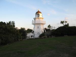a lighthouse with a gold dome on top of it at Jacks place in Moeraki