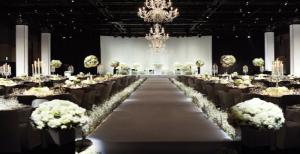 a banquet hall with a long aisle with white flowers at The Shilla Seoul in Seoul +37 photos