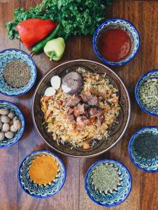 a table with a plate of food and bowls of spices at Hyatt Regency Tashkent in Tashkent