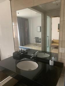 a bathroom with two sinks and a large mirror at Feima Hotel in Antananarivo