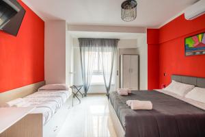 two beds in a room with red walls at Borgo Santa Lucia B&B in Naples