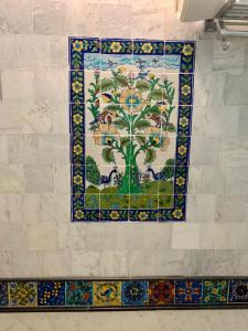 a mosaic tile wall with a tree on it at Jaipur Haveli in Jaipur