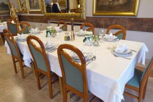 a table in a restaurant with a white table cloth at Hotel Vila Tina in Zagreb