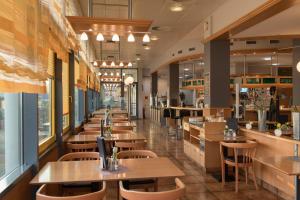 a restaurant with wooden tables and chairs at An der A 30 UG in Bünde