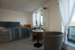 a bedroom with a bed and a table and a chair at An der A 30 UG in Bünde