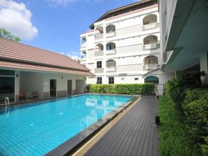 a swimming pool in front of a building at P Park Residence Suvarnabhumi in Bangkok