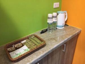 a counter with a basket and two glasses of water at 62 House in Hualien City