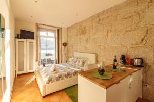 a kitchen with a bed, table and a window at Happy Porto Hostel & Apartments in Porto