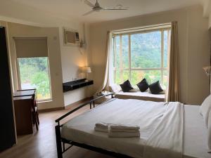 a bedroom with two beds and a large window at Aloha Serenity Apartments in Rishīkesh +71 photos