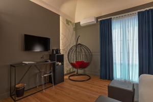 TV a/nebo společenská místnost v ubytování Palco Rooms&Suites