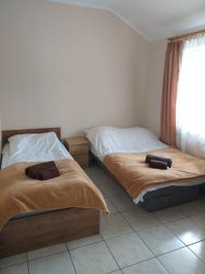 dos camas sentadas una al lado de la otra en un dormitorio en Zajazd Ostoja, en Stary Dzierzgoń