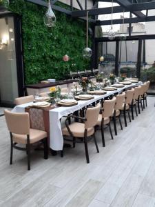 a long long table with chairs and plates on it at Hotel Litovel in Komárno