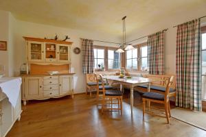 a kitchen and dining room with a table and chairs at Landhaus Jägerhof in Going