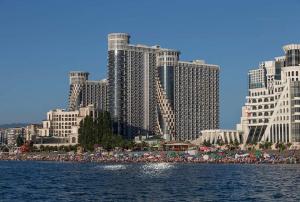 a view of a city with tall buildings and a beach at Apartment Twin Towers David in Batumi