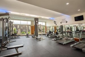 a gym with several treadmills and machines at The Phoenix Hotel Yogyakarta - Handwritten Collection in Yogyakarta