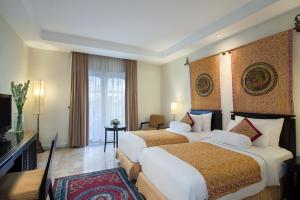 The Phoenix Hotel Yogyakarta - Handwritten Collection客房内的一张或多张床位