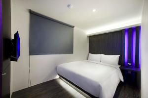 Letto o letti in una camera di Seven Fukun Hotel