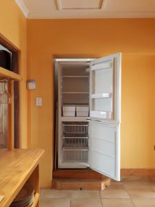 een witte koelkast met de deur open in een keuken bij Blue Tides in Port Elizabeth