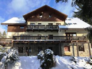 a large house with snow on the ground at Chalet Hřebenka in Harrachov
