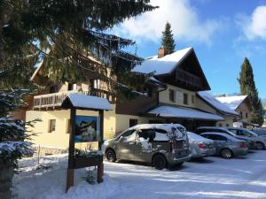 a car parked in a parking lot in front of a house at Chalet Hřebenka in Harrachov