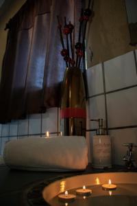 a towel and a vase with candles on a counter at Elephant's Nest in Graskop