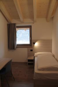 Posteľ alebo postele v izbe v ubytovaní MOUNTAIN RESORT Appartamenti