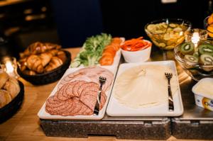 a table with two plates of food with meat and vegetables at Zone Apartments in Ruka