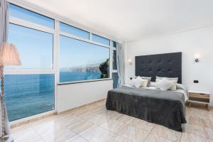 a bedroom with a bed and a large window at Ocean Vistas 24 in Puerto de la Cruz +45 photos