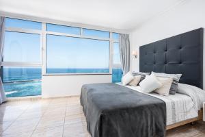 a bedroom with a large bed with a large window at Ocean Vistas 24 in Puerto de la Cruz