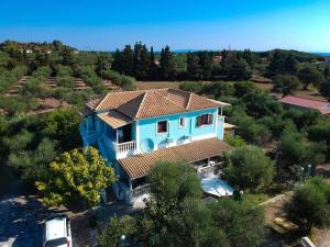 an aerial view of a blue house with trees at Areti Orfeas Studios in Vasilikos