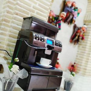 a coffee machine with a cup on top of it at Devon Begi Heritage Hotel in Bukhara